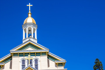 Fototapeta na wymiar Old Church Bell Tower With Cross