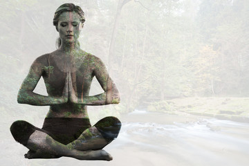 Calm blonde sitting in lotus pose with hands together against rapids flowing along lush forest