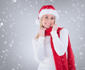Festive blonde smiling at camera against grey vignette