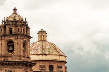 Obraz premium Bell tower and dome of the Temple of the Company of Jesus in Cusco (Peru) in front of the main square