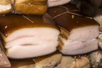 smoked pork fatback with skin on the counter