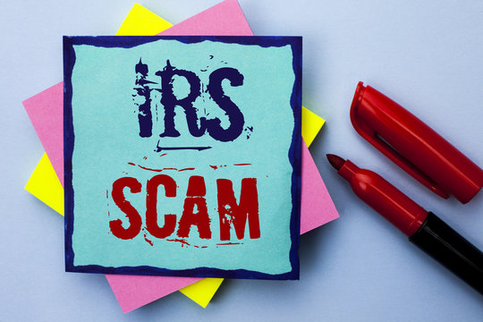 Writing note showing  Irs Scam. Business photo showcasing Warning Scam Fraud Tax Pishing Spam Money Revenue Alert Scheme written on Sticky Note Paper on the Plain background Marker next to it.