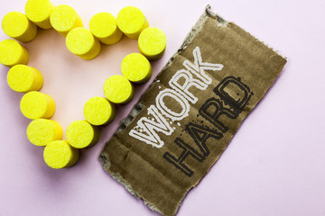 Text sign showing Work Hard. Conceptual photo Struggle Success Effort Ambition Motivation Achievement Action written on Tear Cardboard Piece on the plain background with Heart next to it.