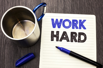 Conceptual hand writing showing Work Hard. Business photo showcasing Struggle Success Effort Ambition Motivation Achievement Action written on Notebook Paper wooden background Marker and Cup
