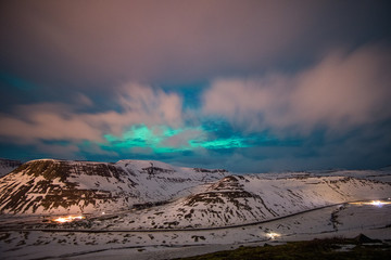 northern lights over mountains in iceland