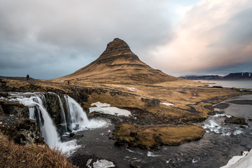 Kirkjufell mountain in Iceland and a cloudy sunset