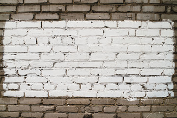 Old realistic dirty brick wall made of white brick. White uneven brickwork. Center of wall is painted white. Big rectangle for mock up in center of shot close-up.