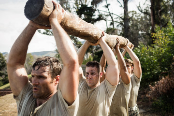 Soldiers carrying a tree log