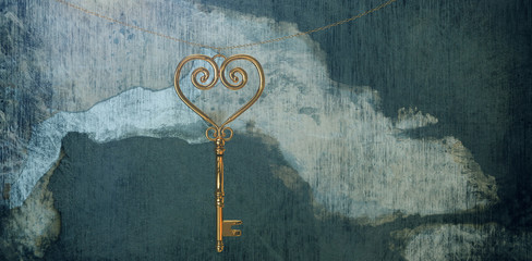 Gold heart key against rusty weathered wall