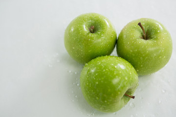 Close-up of green apples with water droplets