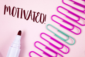 Writing note showing  Motivated Motivational Call. Business photo showcasing Willing to do something Inspired Confident written on Plain Pink background Marker and Paper Pins next to it.