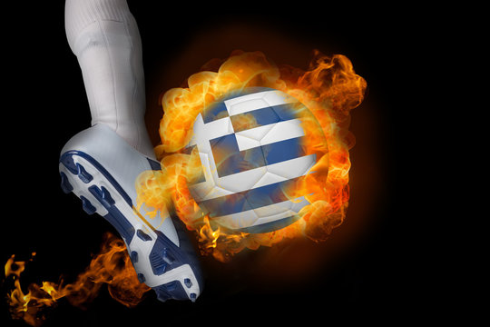 Football player kicking flaming greece flag ball against black