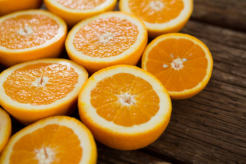 Fototapeta na wymiar Halved oranges on wooden table