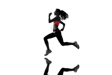 Fototapeta na wymiar Full length of healthy woman jogging against mirror