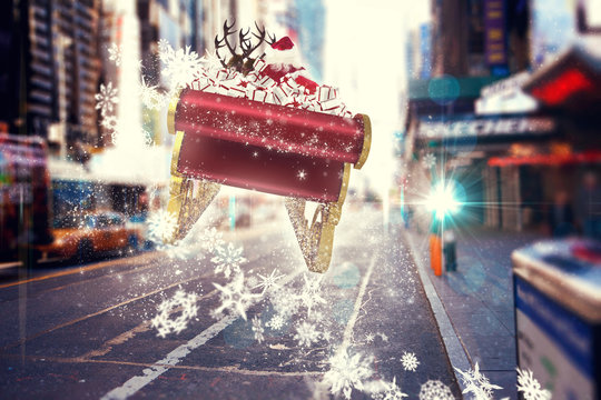 Santa flying his sleigh against blurry new york street