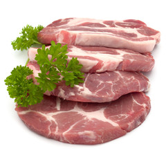 Raw pork neck chop meat with parsley herb leaves garnish isolated on white background cutout