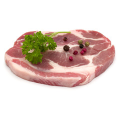 Raw pork neck chop meat with parsley herb leaves and peppercorn spices garnish isolated on white background cutout