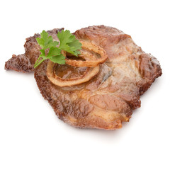 Cooked fried pork meat with parsley herb leaves and onion slices garnish isolated on white background cutout