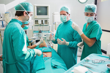 Surgery team operating a patient in an operating theater