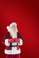 Santa Claus wears boxing gloves against red background