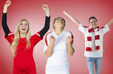 Composite image of football fans against red vignette