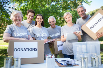 Happy volunteer family holding donation boxes 