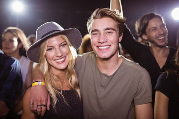 Portrait of smiling friends standing at nightclub