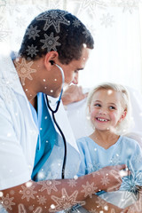 Attractive doctor checking the pulse on a young patient against snowflakes