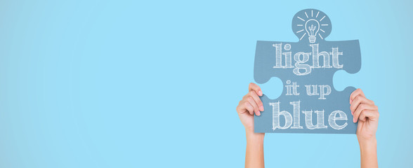 Hands showing jigsaw puzzle against blue background with vignette