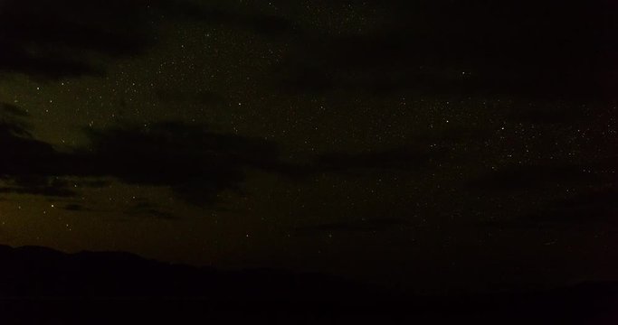 timelapse of stars moving against the landscape of death valley national park in california shot from the salt flats of badwater basin