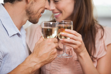 Close-up of a couple toasting wine glasses