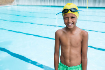 Smiling boy standing near poolside