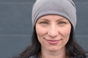 Smiling woman wearing gray beanie hat
