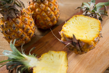 Close-up of halved pineapple on chopping board