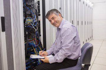 Fototapeta premium Happy technician repairing the server