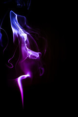 Colorful trickle of smoke on a dark background