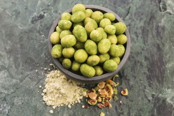 Pile of wasabi coated peanuts in bowl
