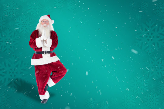 Father Christmas doing some yoga against green snowflake background