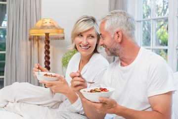 Mature couple having breakfast in bed