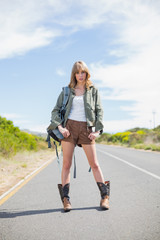 Fototapeta premium Mysterious sexy blonde posing while hitchhiking