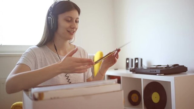 Young audiophile enjoy music and rotate music record