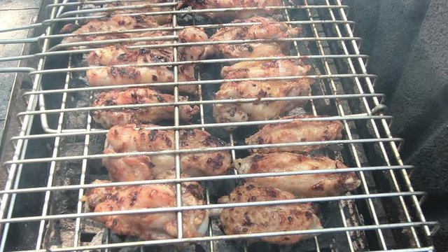 Chicken meat wings that turn over on a barbecue grill.Meat is fried in Mangal Barbecue grill. Chicken meat on the gril