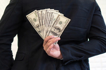 business man  holding money US dollar bills in hand , concept for success business