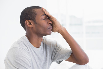 Close up side view of a thoughtful young Afro man