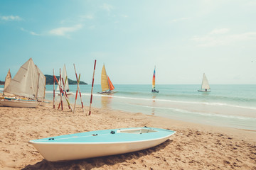 Sailboat on sand tropical beach in summer. vintage retro color tone effect