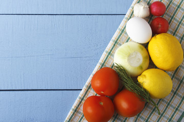 Raw ingredients on wooden background. Fresh vegetables and egg for cooking. Top view with copy space