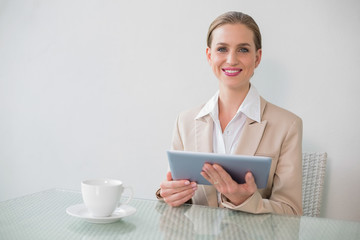 Lucky stylish businesswoman using tablet