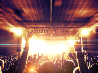 Interior view of a night gig with festive crowd.