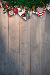 Festive christmas wreath against bleached wooden planks background