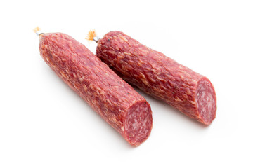 Salami smoked sausage, basil leaves and peppercorns isolated on white background.